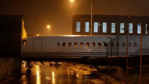 The nose of the plane can be seen lodged into the side of an airport building at Malta International airport on 27 December 2017.